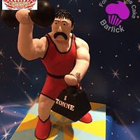 Stromboli the strong man from the fairground at twilight cake carnival room