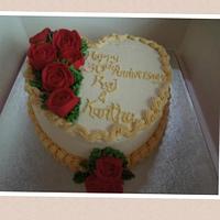 Heart shaped cake decorated with buttercream roses