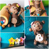 Cute monkeys playing on cake