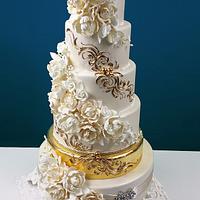 Cascading Foral Bouquets with a Golden Tier Wedding Cake