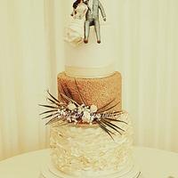 Three tier ivory and gold wedding cake 