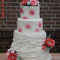 Handpainted wedding cake with ruffles, peonies and roses