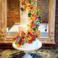 Tropical flower wedding cake with hidden beach scene