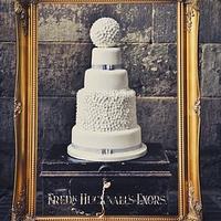 Four tier wedding cake with pomander ball & blossoms