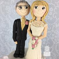 Dusky pink wedding cake with 10 sugar figures