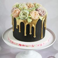Gold drip cake with piped flowers