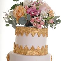 Oppulent gold and peach wedding cake