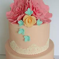 Peach wedding cake with roses and lace
