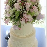 Wedding cake with lace and real flowers....