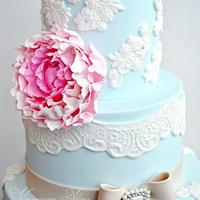 blue wedding cake with a delicate peony