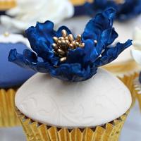 a royal blue and lace wedding cake and cupcakes 