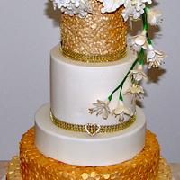 Gold confetti cake with sugar flowers