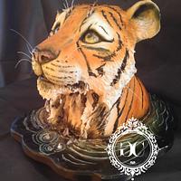 Tiger looking up cake