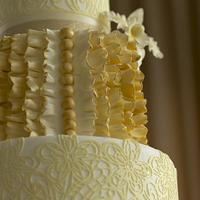 Ivory and gold wedding cake with edible lace and sugar Cattleya orchid