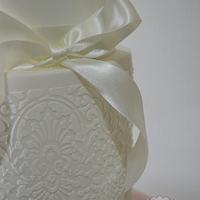 Simple white celebration or wedding cake with magnolia flower