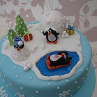 Penguins having fun in the snow cake