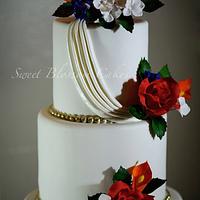 Wedding cake with fall colored sugar flowers and little gold accent