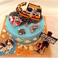 Seals, boat and puppies cake with jewellery cupcakes
