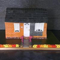 replica bungalow building birthday cake