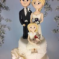 Ivory wedding cake with bride groom and flower girl sugar topper 