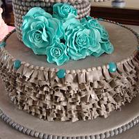 Grey wedding cake with ruffles and lace