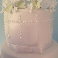 Elegant pearls and peonies wedding cake