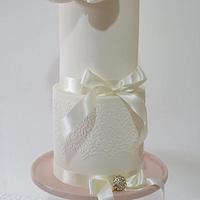 Simple white celebration or wedding cake with magnolia flower
