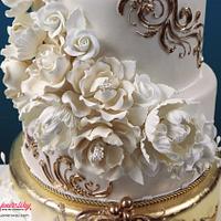 Cascading Foral Bouquets with a Golden Tier Wedding Cake