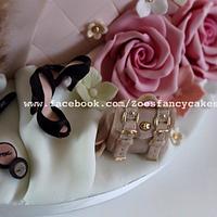 Pink themes present cake including shoes, flowers and mulberry bag