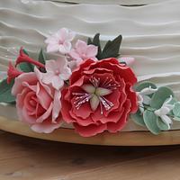Handpainted wedding cake with ruffles, peonies and roses