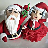 Santa and Mrs. Claus under the mistletoe
