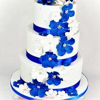 wedding cake with blue and white flowers