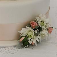 Simple three tier wedding cake with fresh flowers