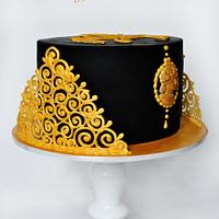 black and gold cake with logo