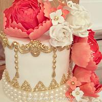 Coral, white and gold wedding cake