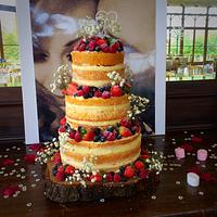 Naked wedding cake with fresh forest fruit 