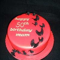 Butterfly scaling 50th birthday cake
