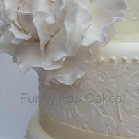 Ivory wedding cake with lace and sugar peony