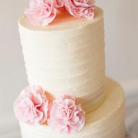 Grey ombre buttercream wedding cake with pink ruffled ribbon roses