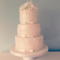 Elegant pearls and peonies wedding cake