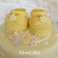 Christening cake with yellow shoes