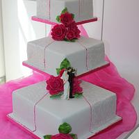 3 Tier square embossed wedding cake with Hot pink handmade roses