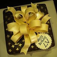 Elite Cake Designs - Beautifuly desgined Louis Vuitton gift box cake with  golden bow and pattern consisting of individually embossed symbols!