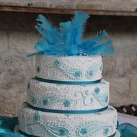 Blue/ Teal Paisley wedding cake with feather and crystal topper