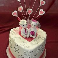 silver hearts and hot pink ribbon with teddy bear cake topper