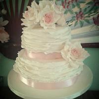 ivory frills and roses wedding cake with a hint of pink