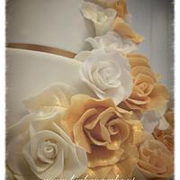Wedding Cake with roses and a touch of gold.