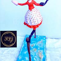 Woman on tightrope cake