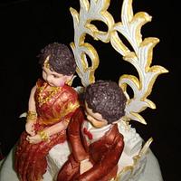 Wedding cake with bride in saree.