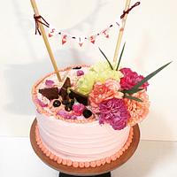 Cream cake with fresh carnations